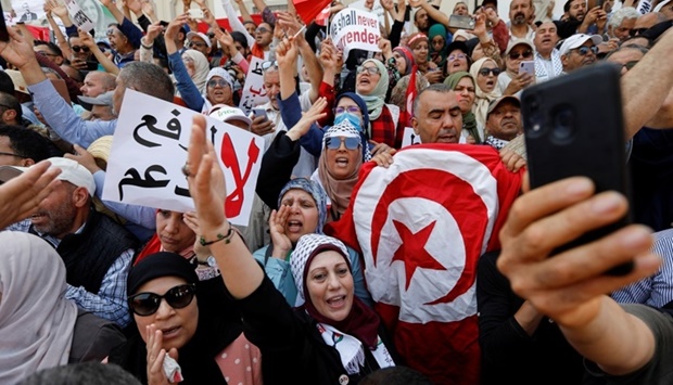 Demonstrators carry banners and flags during a protest against Tunisian President Kais Saied in Tunis, Tunisia. REUTERS