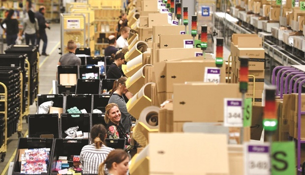 Amazon workers sort and pack items at the Amazon Fulfilment Centre in Peterborough. Amazon, the second largest employer in the United States, revealed that its ranks are overly plump after ending last year with more than twice as many workers as it had in 2019.