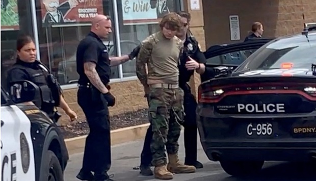 A man is detained following a mass shooting in the parking lot of TOPS supermarket, in a still image from a social media video in Buffalo, New York, US. Courtesy of BigDawg/ via REUTERS