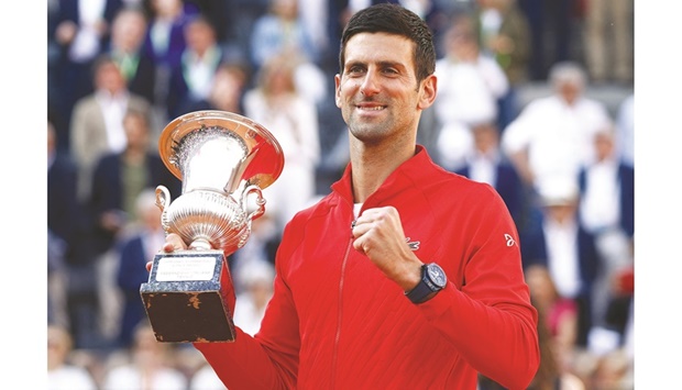 Serbiau2019s Novak Djokovic celebrates with the trophy after winning the Italian Open final against Greeceu2019s Stefanos Tsitsipas at the Foro Italico in Rome yesterday. (Reuters)