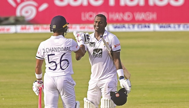 Sri Lankau2019s Angelo Mathews (right) celebrates with teammate Dinesh Chandimal after scoring a century on the first day of the first Test against Bangladesh at the Zahur Ahmed Chowdhury Stadium in Chittagong yesterday. (AFP)