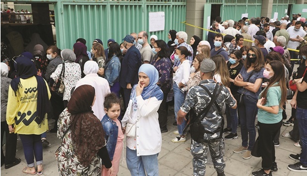 People gather at a polling station, on the day of the Lebanese parliamentary election, in Beirut, yesterday.