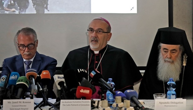 Latin Patriarch of Jerusalem Pierbattista Pizzaballa (C) speaks during a press conference while accompanied by the Greek Orthodox Patriarch of Jerusalem Theophilos III (R) and the General Director of Saint Joseph Hospital Jamil Koussa (L) regarding the events at the funeral of slain Al Jazeera journalist Shireen Abu Akleh, at the hospital in Jerusalem. AFP