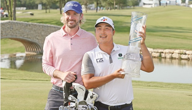 AT&T Byron Nelson champion KH Lee holds the trophy along side caddie Dan Parratt in McKinney, Texas, US. (USA TODAY Sports)