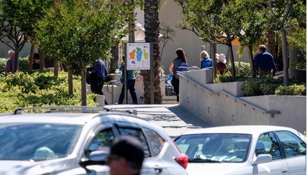 Church goers are seen as police investigate after a shooting inside Geneva Presbyterian Church in Laguna Woods, California. AFP