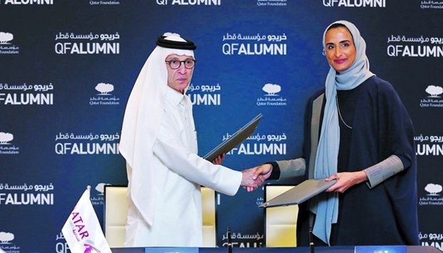 HE Sheikha Hind bint Hamad al-Thani and HE Akbar al-Baker shake hands at the signing ceremony.