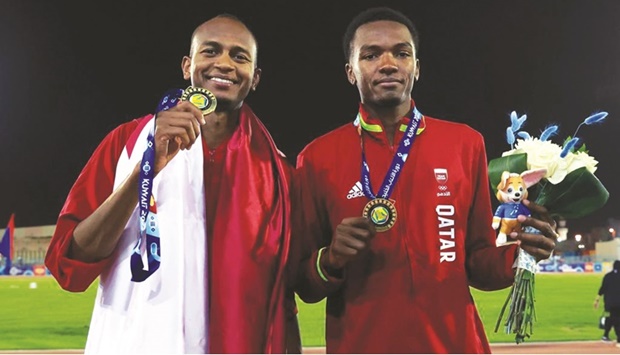 Qataru2019s Mutaz Barshim (left) and Hamdi Ali pose with their high jump gold medals at the GCC Games in Kuwait yesterday.