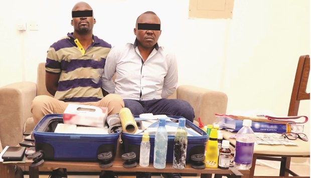 The arrested men with the items that were seized.