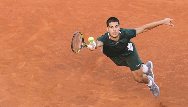Spainu2019s Carlos Alcaraz returns the ball to Germanyu2019s Alexander Zverev during the Madrid Open final on May 8, 2022. At just 19, Alcaraz is bidding to become just the eighth teenager to win a Grand Slam title at the French Open which gets underway on Sunday. (AFP)