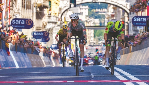 Team Alpecin-Fenix Italian rider Stefano Oldani (centre) celebrates as he crosses the finish line ahead of Team Wantyu2019s Italian rider Lorenzo Rota (right) and Team Jumbou2019s Dutch rider Gijs Leemreize (rear left) to win the 12th stage of the Giro du2019Italia 2022, 204 kilometres from Parma to Genova, yesterday. (AFP)