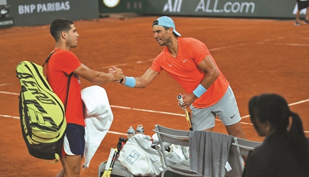 Spainu2019s Rafael Nadal (right) greets compatriot Carlos Alcaraz during a practice session in Paris yesterday, ahead of the French Open.