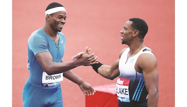 Canadau2019s Aaron Brown (left) celebrates after winning 100m race with second-placed Jamaicau2019s Yohan Blake at the Birmingham Diamond League yesterday. (Reuters)