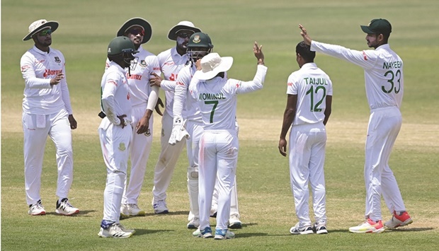 Bangladesh players celebrate the dismissal of Sri Lankau2019s captain Dimuth Karunaratne during the final day of the first Test in Chittagong on Thursday. (AFP)