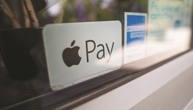 A sticker advertises Apple Pay as an accepted payment method at a restaurant in Norwich, UK. The EU accused Apple yesterday of blocking rivals from its popular u201ctap-as-you-gou201d iPhone payment system, opening a fresh battlefront between the US tech giant and Brussels.