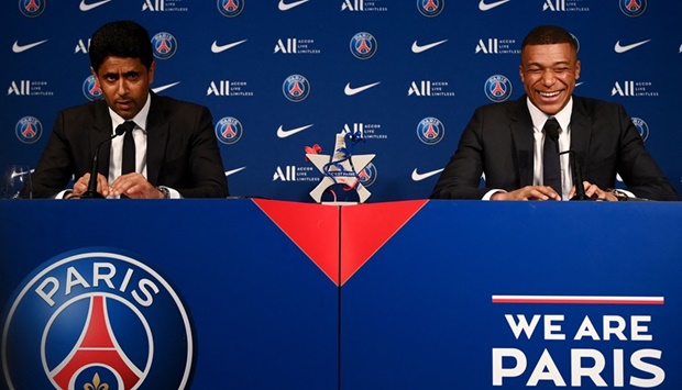 Paris Saint-Germain's CEO Nasser Al-Khelaifi (L) and French forward Kylian Mbappe (R) give a press conference at the Parc des Princes stadium in Paris on May 23, 2022, two days after the club won the Ligue 1 title for a record-equalling tenth time and its superstar striker Mbappe chose to sign a new contract until 2025 at PSG rather than join Real Madrid.
