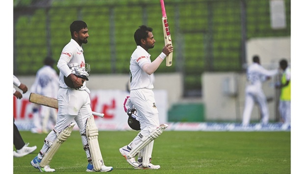 Bangladeshu2019s Mushfiqur Rahim (right) and Liton Das walk back to the pavilion at the end of the first dayu2019s play of the second Test against Sri Lanka at the Sher-e-Bangla National Cricket Stadium in Dhaka yesterday. (AFP)