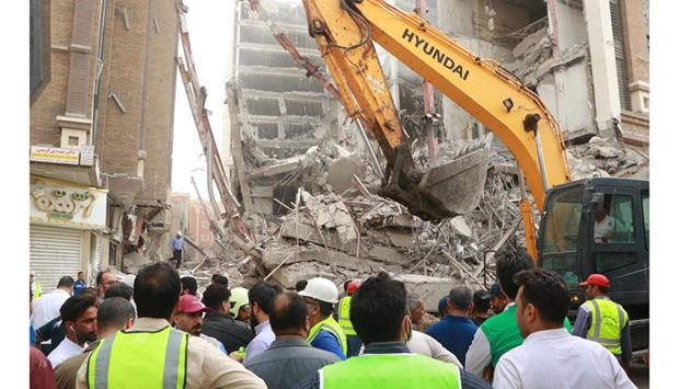 Rescue crews work at the site of a ten-storey building collapse in Abadan.