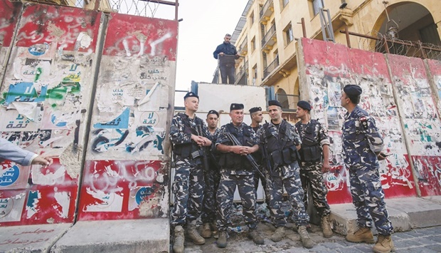 Lebanese police stand guard after sections of the concrete barrier, which was erected by the security forces in 2020 to bar access to streets leading to the countryu2019s parliament building, were removed at the entrance of the Lebanese Parliament in the capital Beirut yesterday.