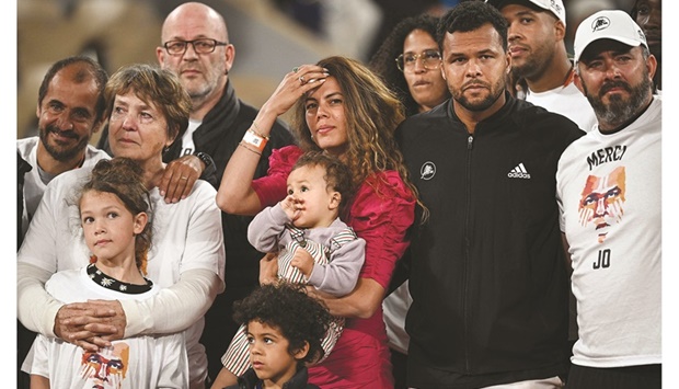 Franceu2019s Jo-Wilfried Tsonga (second right) poses with family members and relatives after receiving a trophy to mark his retirement from tennis at the end of his match against Norwayu2019s Casper Ruud on day three of the French Open at Roland Garros at the Court Philippe-Chatrier in Paris yesterday. (AFP)