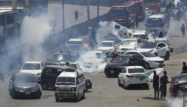 Police use tear gas to disperse activists of the Pakistan Tehreek-e-Insaf (PTI) party of ousted prime minister Imran Khan during a protest in Lahore on May 25, 2022, as all roads leading into Pakistan's capital were blocked ahead of a major protest planned by ousted prime minister Imran Khan and his supporters.