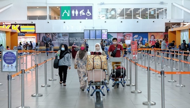 Travellers with their baggage at Kuala Lumpur International Airport 2 in Sepang. Tourism Malaysia places a strong emphasis on attracting tourists from Qatar and elsewhere in the GCC following the reopening of the Southeast Asian countryu2019s borders for international tourists on April 1, 2022.
