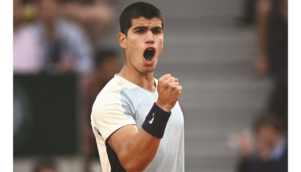 Spainu2019s Carlos Alcaraz celebrates after winning his second round match against compatriot Albert Ramos-Vinolas at the French Open in Paris yesterday. (AFP)