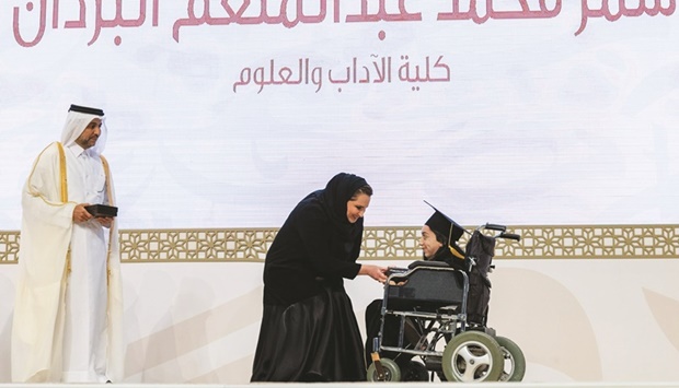 is Highness the Amir's consort Her Highness Sheikha Jawaher bint Hamad bin Suhaim al-Thani honours a graduate at the ceremony on Thursday.