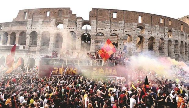 AS Romau2019s players celebrate on top of an open bus as they parade in front of the Colisseum in Rome yesterday, a day after winning the UEFA Conference League final match against Feyenoord Rotterdam. (AFP)