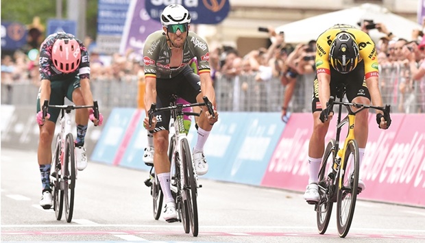 Alpecin-Fenixu2019s Dries De Bondt (centre) crosses the finish line to win Stage 18 of the Giro du2019Italia in Treviso, Italy, yesterday. (Reuters)