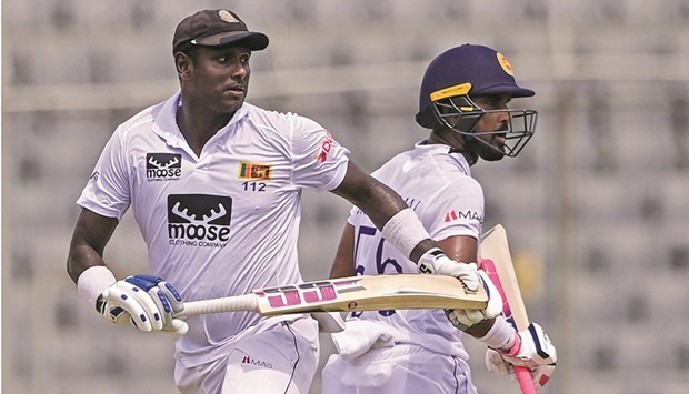 Sri Lankau2019s Angelo Mathews (left) and Dinesh Chandimal take a run during the fourth day of the second Test against Bangladesh at the Sher-e-Bangla National Cricket Stadium in Dhaka yesterday. (AFP)