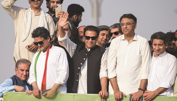 Former prime minister Imran Khan waves to party supporters during a rally in Islamabad yesterday.
