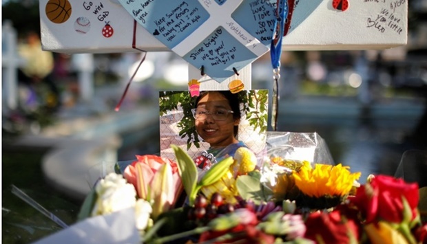 A picture of Alexandria Rubio, one of the victims of the Robb Elementary school shooting, is left at a memorial in Town Square in front of the county courthouse, three days after a gunman killed nineteen children and two adults, in Uvalde, Texas, US. REUTERS