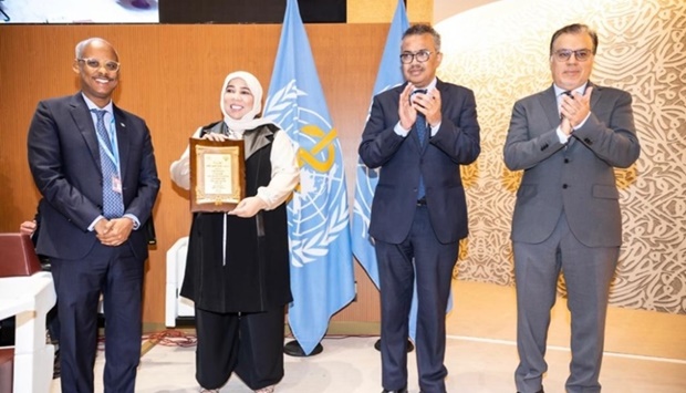 Dr Hanadi al-Hamad receives the award as Kuwait's Minister of Health Dr Khaled al-Saeed (right), as WHO Director-General Dr Tedros Adhanom Ghebreyesus and Djibouti Health Minister Dr Ahmed Robleh Abdilleh (left) look on Friday at the 75th World Health Assembly in Geneva, Switzerland.