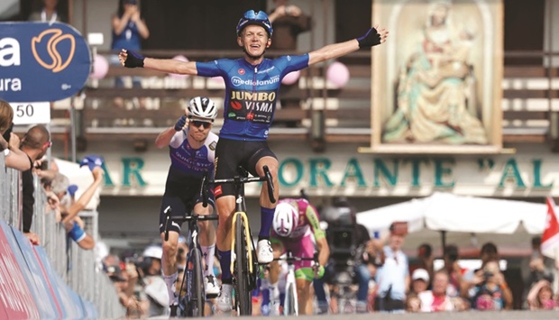 Team Jumbou2019s Dutch rider Koen Bouwman celebrates as he crosses the finish line to win the 19th stage of the Giro du2019Italia 2022 yesterday. (AFP)
