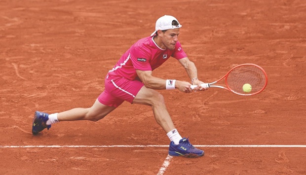Argentinau2019s Diego Schwartzman returns to Bulgariau2019s Grigor Dimitrov during their singles match on day six of the French Open at the Court Simonne-Mathieu in Paris yesterday. (AFP)