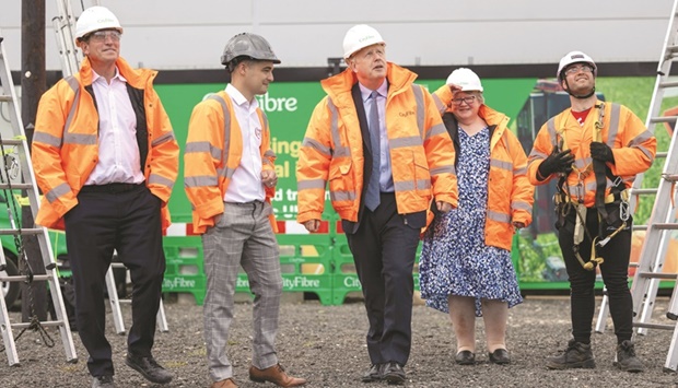 British Prime Minister Boris Johnson, accompanied by Work and Pensions Secretary Therese Coffey, visits the CityFibre Training Academy in Stockton-on-Tees, Britain, yesterday.