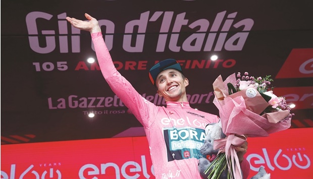 New overall leader Team Borau2019s Australian rider Jai Hindley celebrates on the podium after the 20th stage of the Giro du2019Italia 2022 cycling race, 168 kilometres from Belluno to Marmolada (Passo Fedaia), yesterday. (AFP)