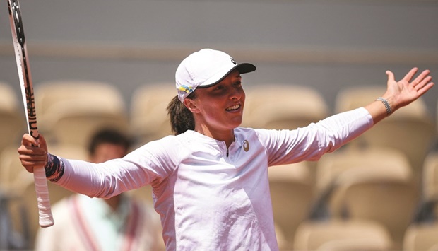 Polandu2019s Iga Swiatek celebrates after her win over Montenegrou2019s Danka Kovinic at the French Open in Paris yesterday. (AFP)
