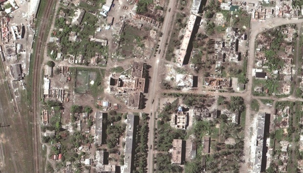 This satellite image released by Maxar Technologies shows destroyed buildings downtown and vehicles in convoy in Popasna, Ukraine. Moscow-backed separatist forces in eastern Ukraine say they have captured Lyman, a strategic town between the city of Severodonetsk and the eastern administrative centre of Kramatorsk, which remain under Kyivu2019s control. The pro-Russian separatists in the Donetsk region say they have u201cliberated and taken full control of 220 settlements, including Krasny Limanu201d, using an old name for Lyman. (AFP)