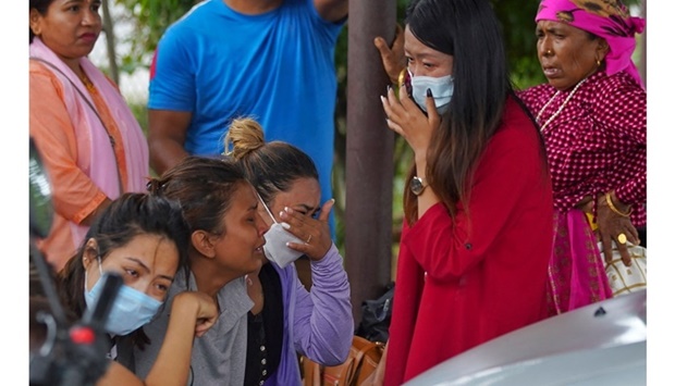 Family members and relatives of passengers on board the Twin Otter aircraft operated by Tara Air, weep outside the airport in Pokhara