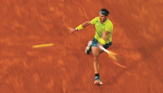 Spainu2019s Rafael Nadal returns the ball to Canadau2019s Felix Auger-Aliassime during their match on day eight of the Roland-Garros Open at the Court Philippe-Chatrier in Paris yesterday. (AFP)