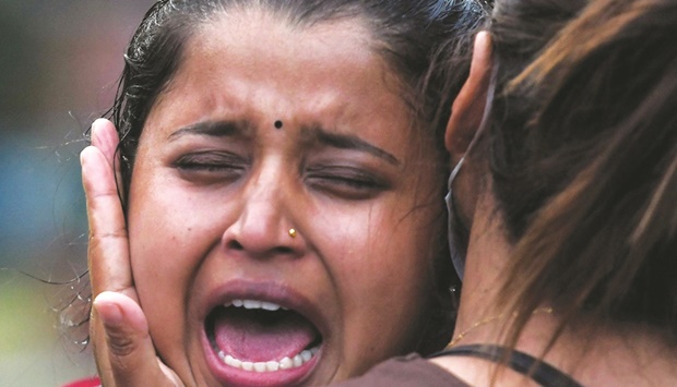 Family members and relatives of passengers weep outside the airport in Pokhara yesterday. (AFP)