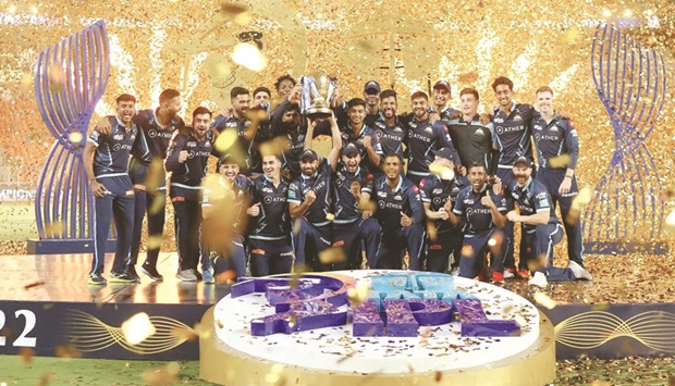 Gujarat Titans captain Hardik Pandya and teammates celebrate with the IPL trophy after their win over Rajasthan Royals in Ahmedabad yesterday.