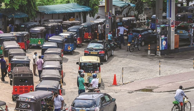 Motorists queue up to buy fuel at a Ceylon Petroleum Corporation fuel station in Colombo yesterday.