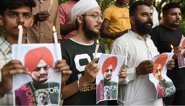 Youth pay tribute to late Punjabi singer Sidhu Moose Wala who was shot dead a day earlier in Mansa district in India's Punjab state, during a candlelight vigil in Amritsar on May 30, 2022.