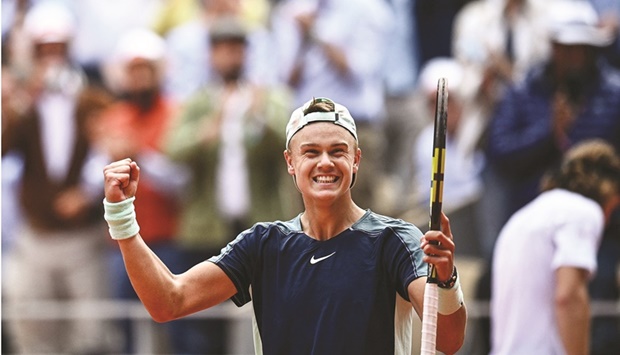 Denmarku2019s Holger Rune celebrates after his win over Greeceu2019s Stefanos Tsitsipas at the French Open in Paris yesterday. (AFP)