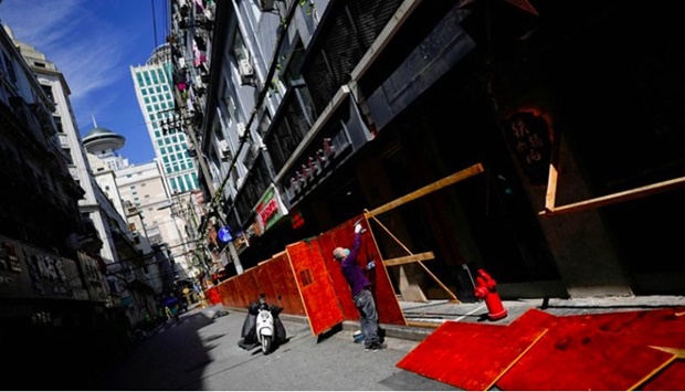A worker dismantles barriers at a residential area, as the city prepares to end the lockdown placed to curb the coronavirus disease (Covid-19) outbreak in Shanghai, China May 31, 2022.