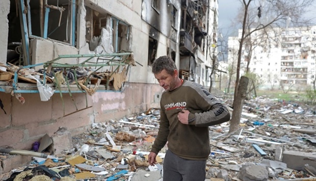 Local resident Viacheslav walks on debris of a residential building damaged by a military strike, as Russia's attack on Ukraine continues, in Sievierodonetsk, Luhansk region, Ukraine on April 16. REUTERS