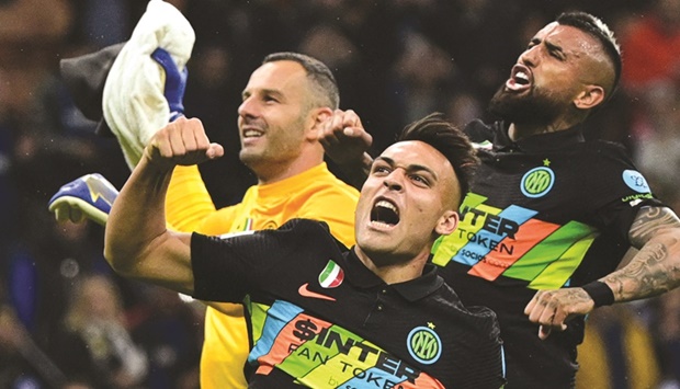 (From left) Inter Milanu2019s goalkeeper Samir Handanovic, forward Lautaro Martinez and midfielder Arturo Vidal celebrate after their win over Empoli in the Serie A match at the San Siro Stadium in Milan yesterday. (AFP)