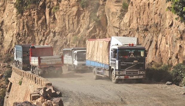 File photo shows vehicles travel along a heavily damaged road, the only travel route between Yemenu2019s cities of Taiz and Aden.